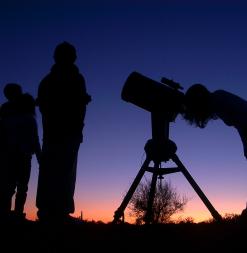 Looking at starts through telescope.
